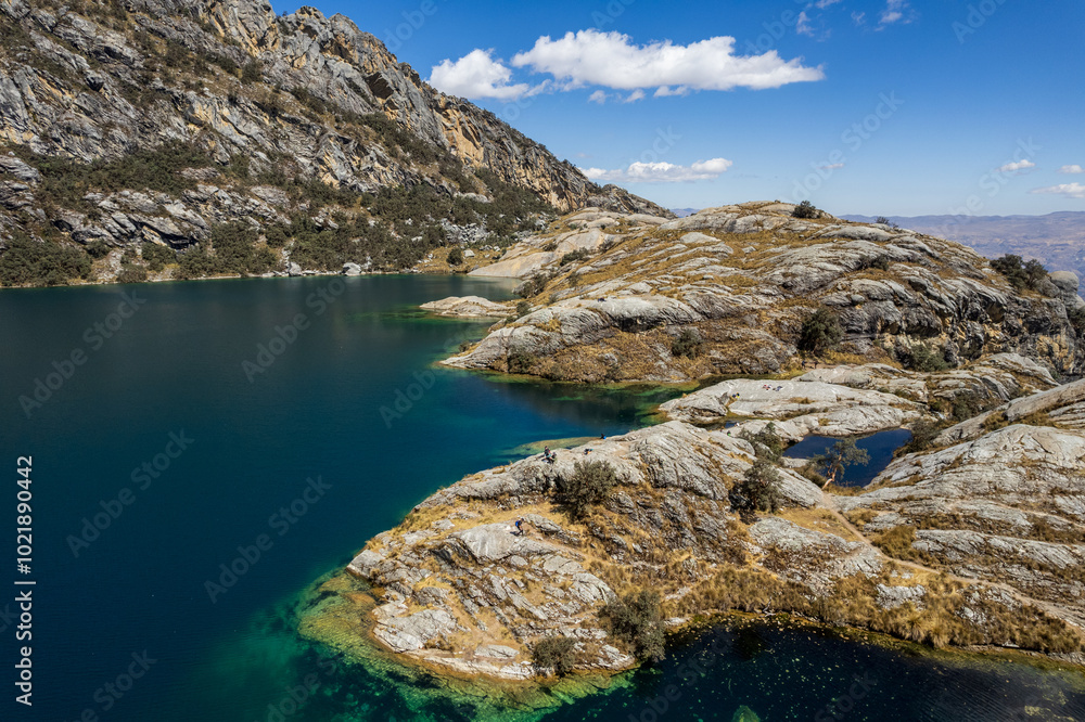 The Turquoise Waters of Churup Lagoon with Tourists Aerial View in the Cordillera Blanca Mountain in the Huascaran National Park, in Ancash, Peru