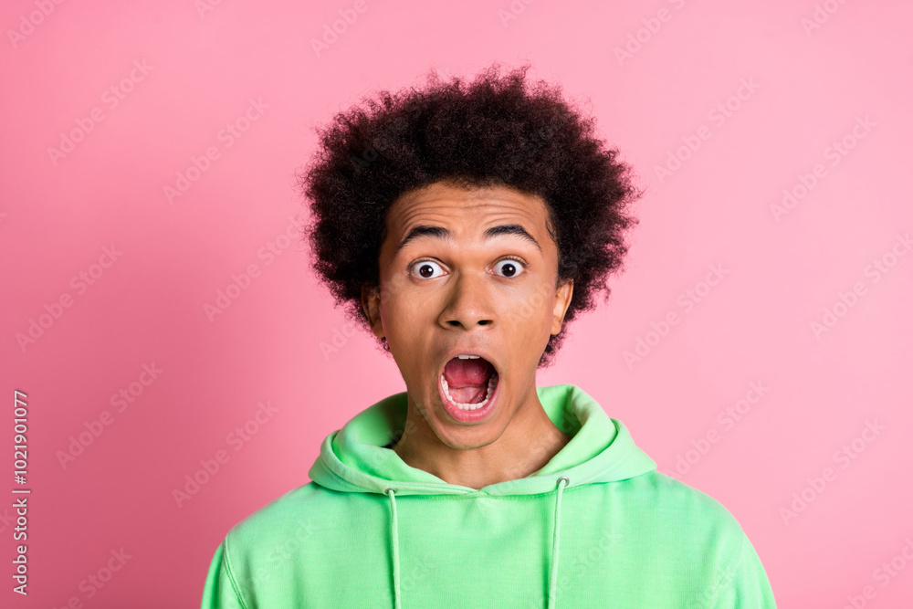 Photo of nice young man open mouth wear green hoodie isolared on pink color background Photo of nice young man open mouth wear green hoodie isolared on pink color background