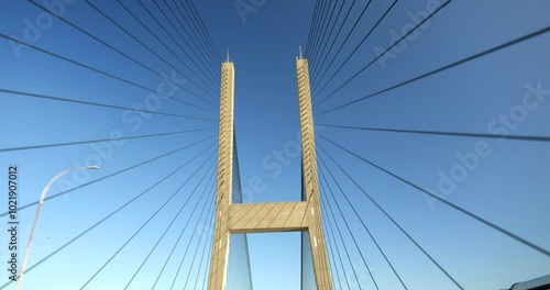 Low angle driving view of a cable suspension bridge in Vancouver British Columbia Canada