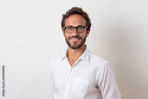 Portrait of a handsome young man in white shirt and glasses.