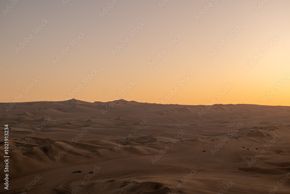 Immense and Dramatic Dune Landscape with Various Buggies Riding by Huacachina in Ica, Peru at Sunset