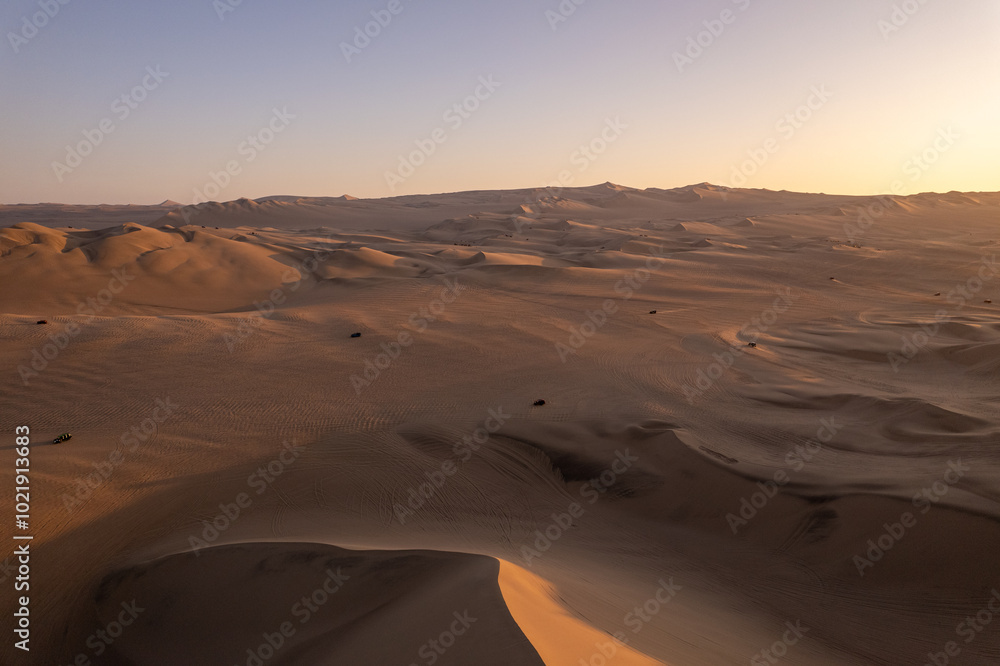 Immense and Dramatic Dune Landscape with Various Buggies Riding by Huacachina in Ica, Peru at Sunset