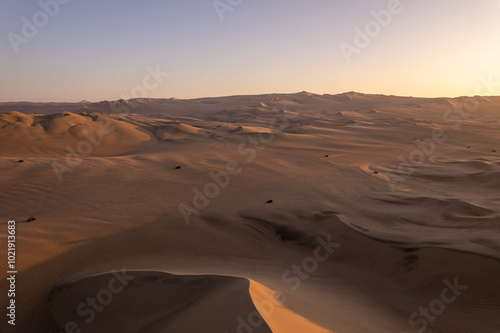 Immense and Dramatic Dune Landscape with Various Buggies Riding by Huacachina in Ica, Peru at Sunset