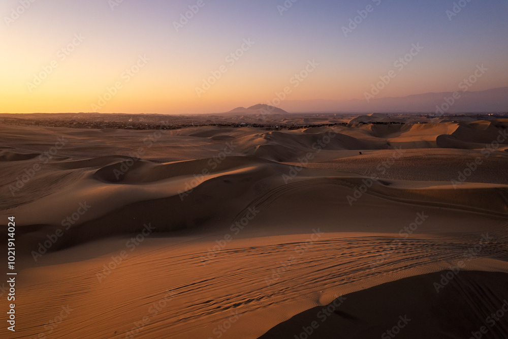 Immense and Dramatic Dune Landscape with Various Buggies Riding by Huacachina in Ica, Peru at Sunset