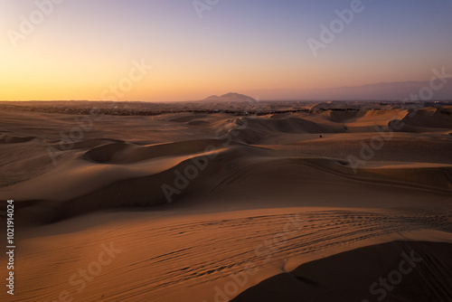 Obraz na płótnie Immense and Dramatic Dune Landscape with Various Buggies Riding by Huacachina in Ica, Peru at Sunset w salonie