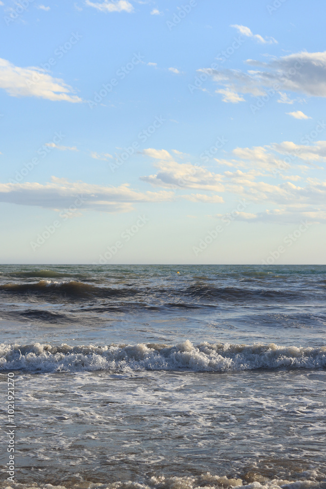 Sea view from the shore. Horizon on the sea. Balearic Sea, Salou, Spain. View of large waves on the sea from a low angle. Landscape. Stormy weather Sea view from the shore. Horizon on the sea. Balearic Sea, Salou, Spain. View of large waves on the sea from a low angle. Landscape. Stormy weather