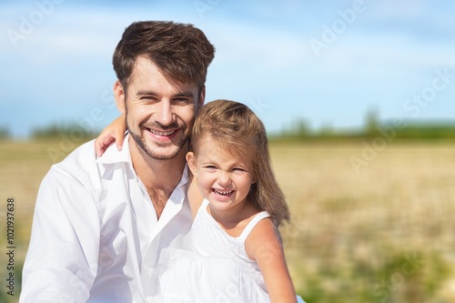 Young happy father with little child daughter outdoors