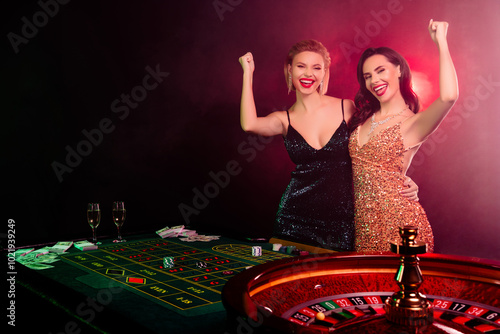 Photo of excited people girls raise fists win black jack million money in roulette wheel lucky number christmas photo