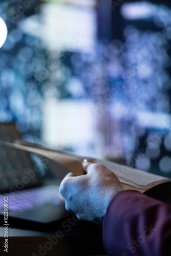 Chief financial officer examining business archive records to provide necessary information for shareholders and investors. Expert working at night to obtain funding, stock operations. Close up.