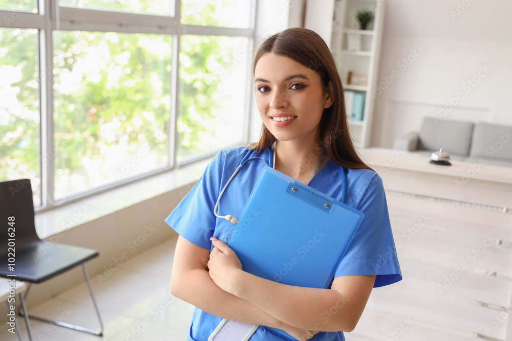 Female medical intern with clipboard at hospital Female medical intern with clipboard at hospital