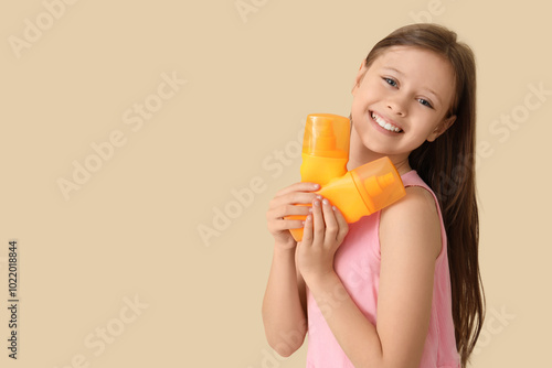 Little girl with bottles of...