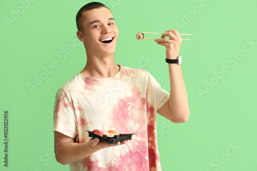 Young man eating tasty sush...