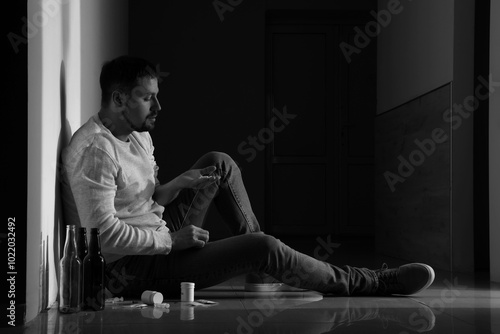 Male drug addict taking pil...