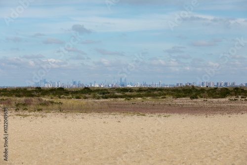 New York City is seen across the water from Sandy Hook, New Jersey. Brooklyn, including the famous Coney Island, can be seen in the front, with Manhattan Island behind. photo