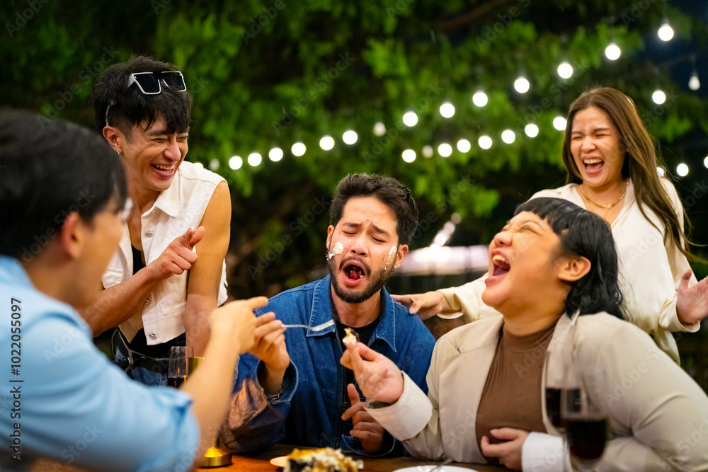 Obraz premium Group of Happy Asian millennials generation people friends enjoy and fun celebration reunion meeting at dinner party and eating dessert cake together in the garden at restaurant on holiday vacation.