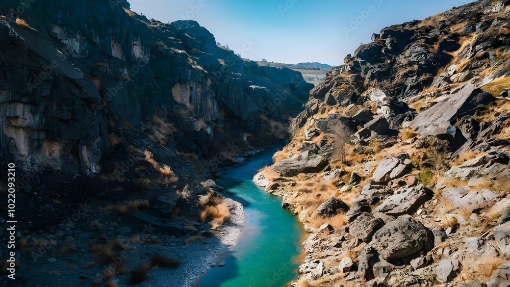 Fototapeta premium River flowing through rocky canyon in bright sunlight
