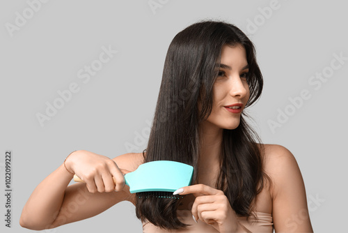 Young woman brushing long d...