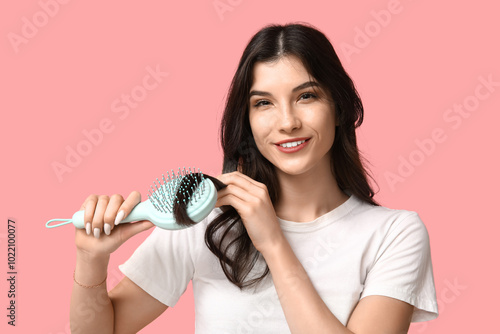 Beautiful young woman brush...