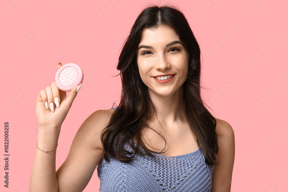 Beautiful young woman with hair brush on pink background Beautiful young woman with hair brush on pink background
