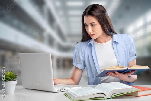 Female business person working in labrary