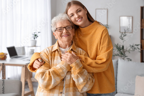 Happy senior woman and her granddaughter at home