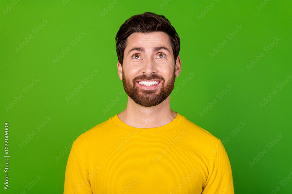 Photo of cheerful nice man with stylish beard dressed yellow shirt look at logo empty space isolated on vibrant green color background Photo of cheerful nice man with stylish beard dressed yellow shirt look at logo empty space isolated on vibrant green color background