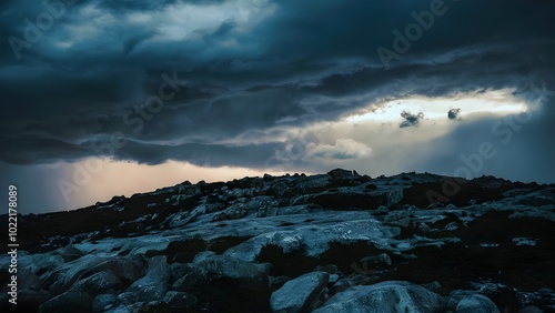 Dramatic weather with storm clouds over rocky hill