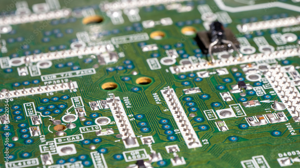 A close up of a circuit board with many small holes A close up of a circuit board with many small holes