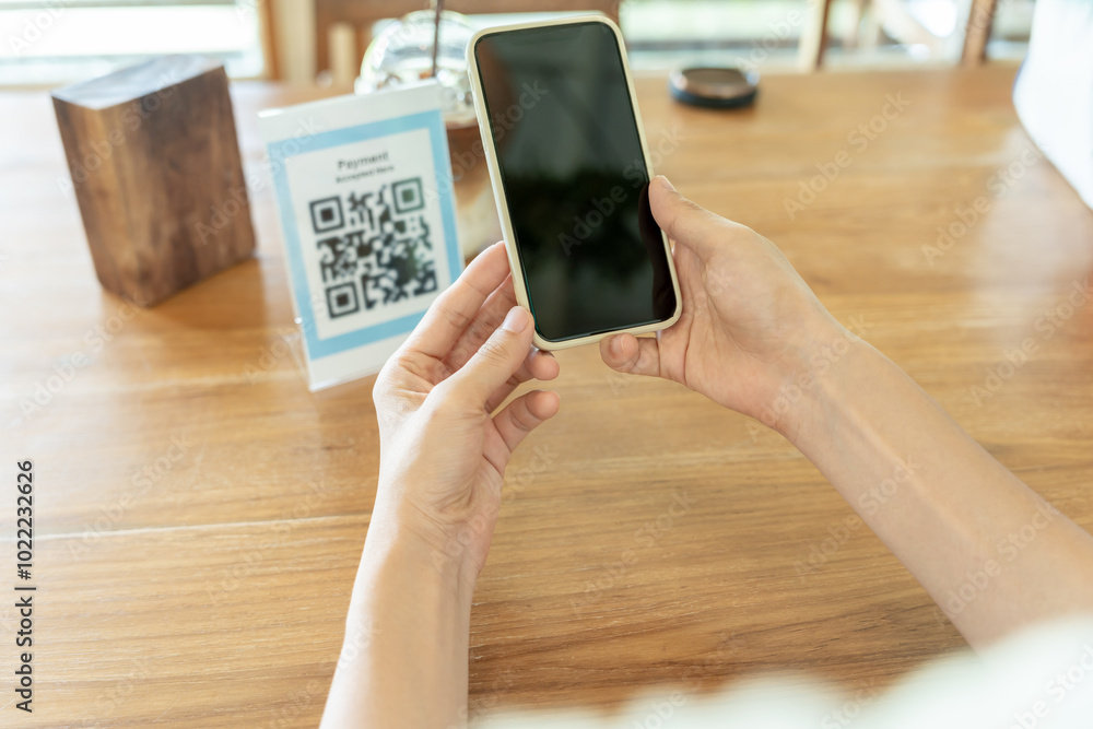 Woman use smartphone to scan QR code to pay in cafe restaurant with a digital payment without cash. Choose menu and order accumulate discount. E wallet, technology, pay online, credit card, bank app. Woman use smartphone to scan QR code to pay in cafe restaurant with a digital payment without cash. Choose menu and order accumulate discount. E wallet, technology, pay online, credit card, bank app.