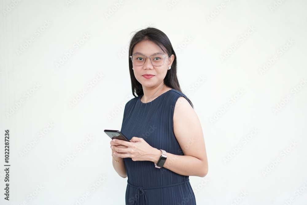 Beautiful Asian Woman wearing formal dress holding and using smartphone, texting or using application concept Isolated On White Background Beautiful Asian Woman wearing formal dress holding and using smartphone, texting or using application concept Isolated On White Background