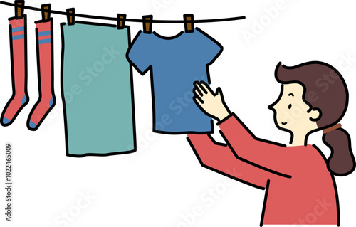 Smiling woman hanging clothes to dry