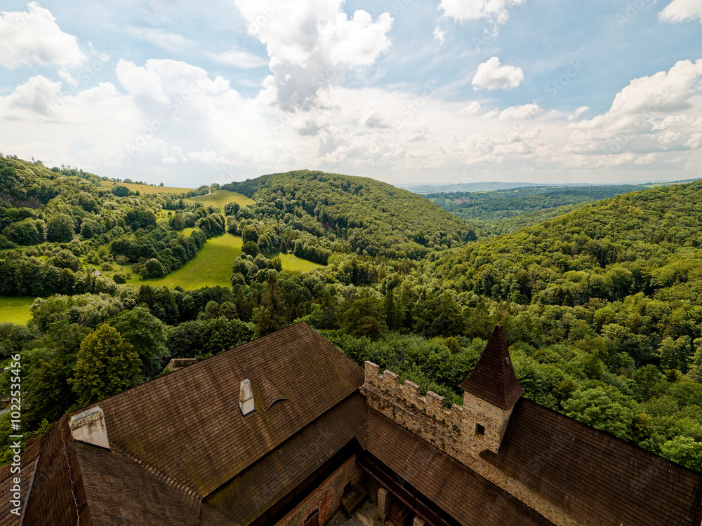 The view from Sovinec Castle in the Bruntál region reveals a stunning landscape of rolling, green hills covered in forests and meadows. Sovinec Castle is the largest castle unit in the area and one of
