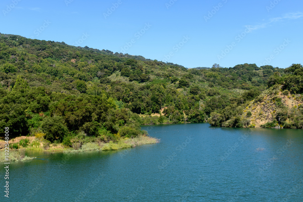 Scenic view of calm water surface of Stevens Creek Reservoir at full capacity in Santa Clara County Scenic view of calm water surface of Stevens Creek Reservoir at full capacity in Santa Clara County