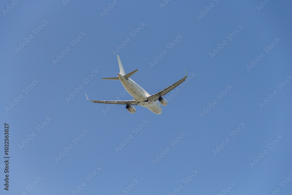 A passenger plane flies in the sky. A passenger plane from below. A passenger plane flies in the sky. A passenger plane from below.