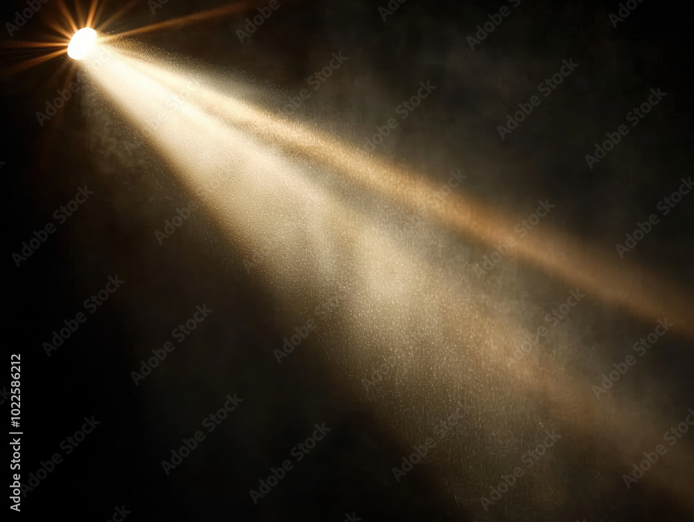 Obraz premium A beam of light shining down from the top left corner, with a black background.The beam is white in color, and its rays spread out to form an oval shape. There are some dust particles floating around 