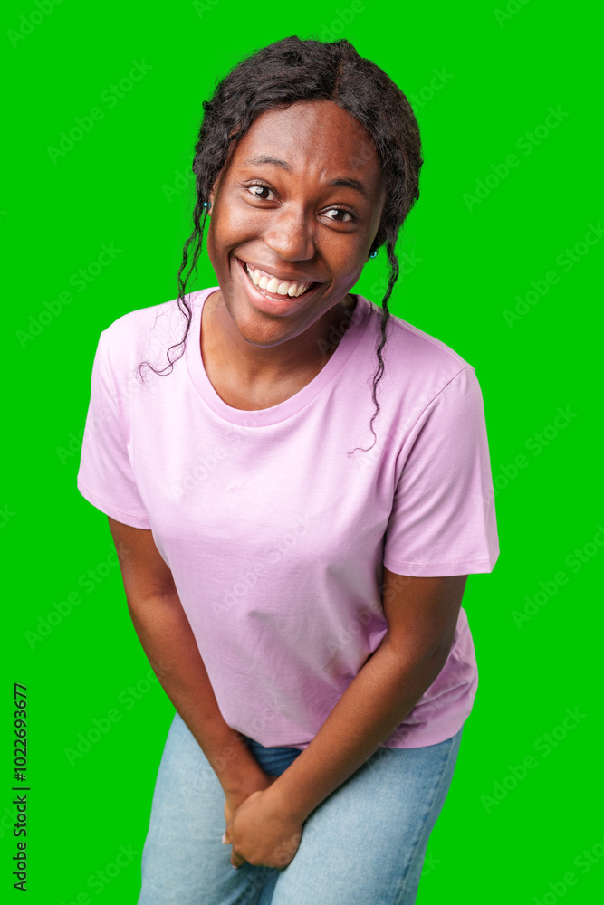 Young woman smiling joyfully in a pink shirt against a vibrant green background in a cheerful atmosphere Young woman smiling joyfully in a pink shirt against a vibrant green background in a cheerful atmosphere