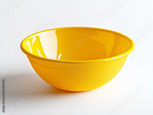 A yellow plastic bowl on white background