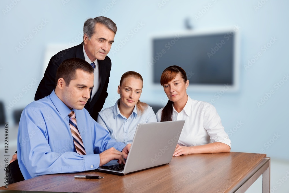 Happy motivated business team brainstorming in office Happy motivated business team brainstorming in office