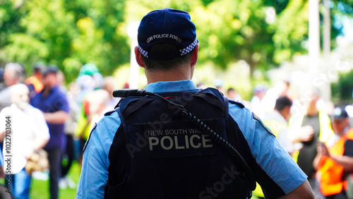 Sydney, NSW Australia - October 6 2024: crime in sydney. Close up of a NSW Police officers uniform sleeve patch and his communication device. australia police