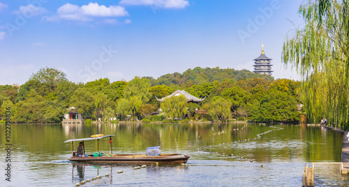 Wooden fishing boat in front of the Leiffeng Pagoda in Hangzhou, China photo