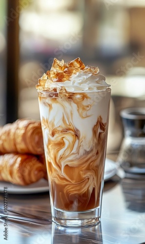 Iced coffee with whipped cream and croissants.