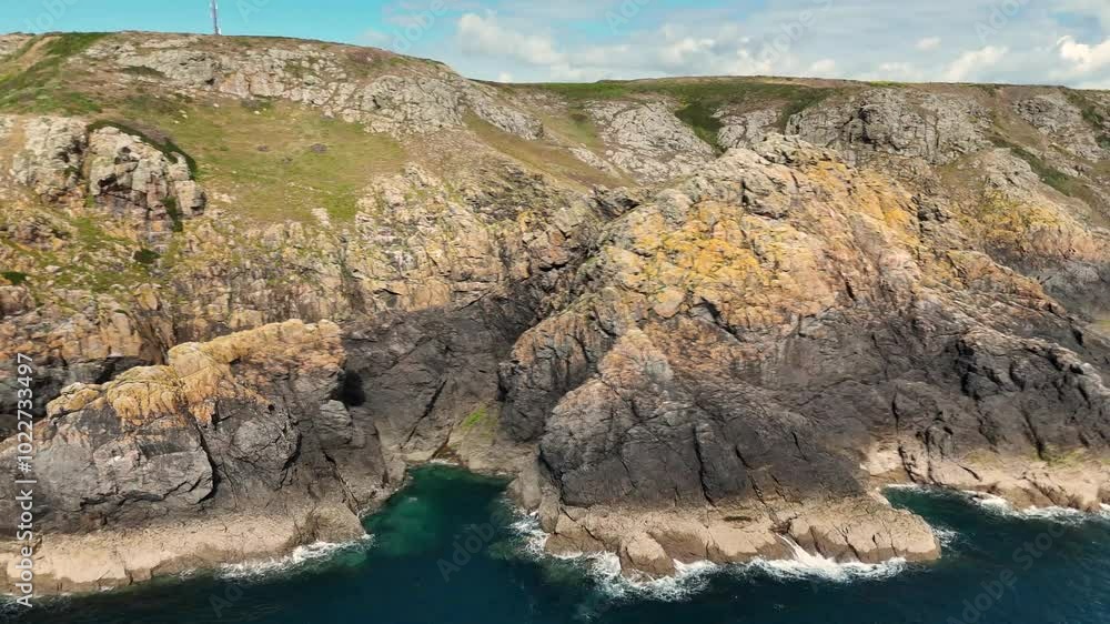 Flight along crevices and inlets of granite cliffs on south coast of Guernsey on bright sunny day Flight along crevices and inlets of granite cliffs on south coast of Guernsey on bright sunny day