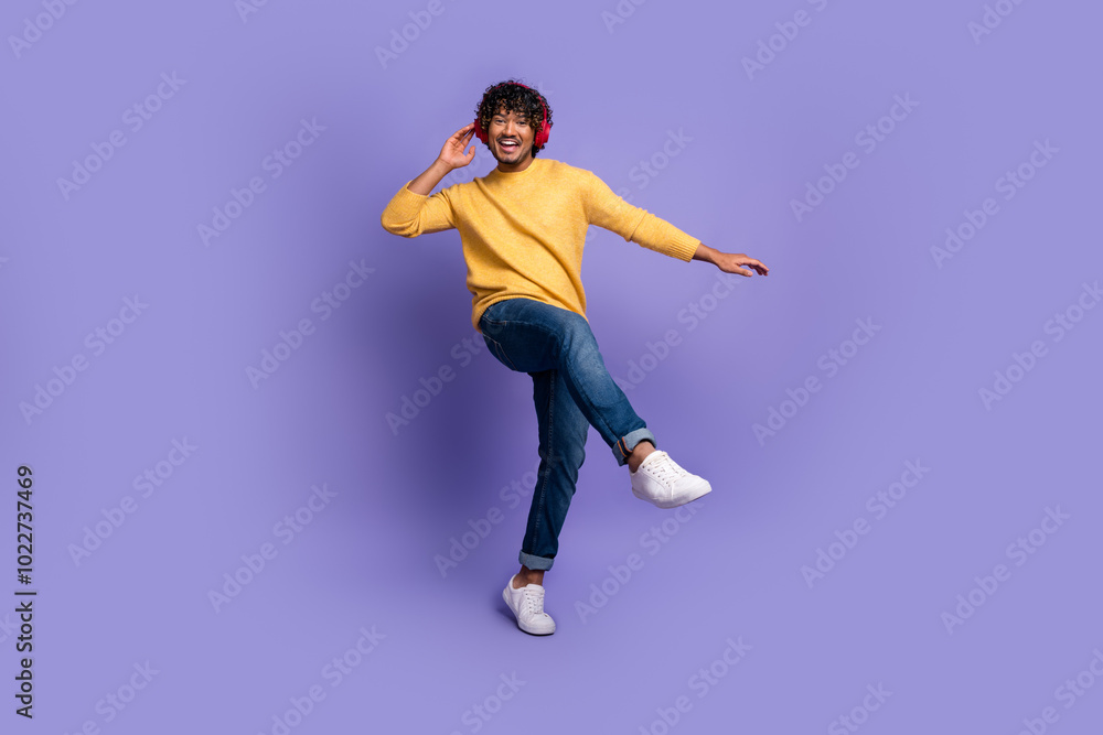 Photo of funky cool nice man wear trendy yellow clothes listen music dance isolated on purple color background Photo of funky cool nice man wear trendy yellow clothes listen music dance isolated on purple color background