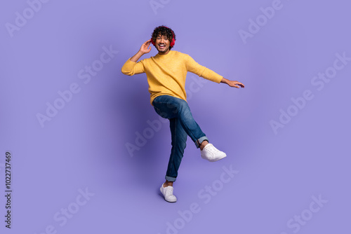 Photo of funky cool nice man wear trendy yellow clothes listen music dance isolated on purple color background