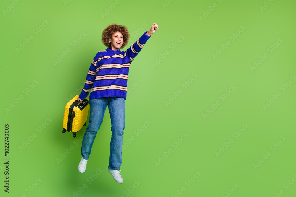 Photo of glad funny tourist wear blue striped trendy clothes hold valise hurry empty space isolated on green color background Photo of glad funny tourist wear blue striped trendy clothes hold valise hurry empty space isolated on green color background