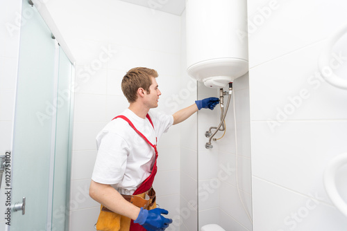 Professional engineer doing a boiler inspection at home photo