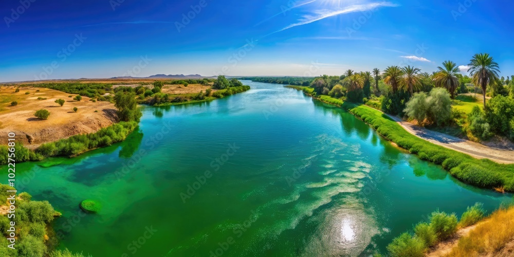 Serene View of Tigris River Flowing Through Lush Green Landscape Under Clear Blue Sky in Iraq Serene View of Tigris River Flowing Through Lush Green Landscape Under Clear Blue Sky in Iraq