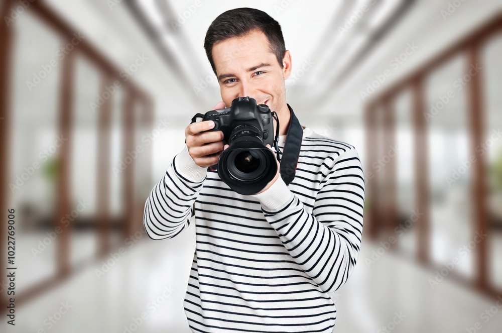 Focused Young Videographer with Professional Camera In Studio Focused Young Videographer with Professional Camera In Studio