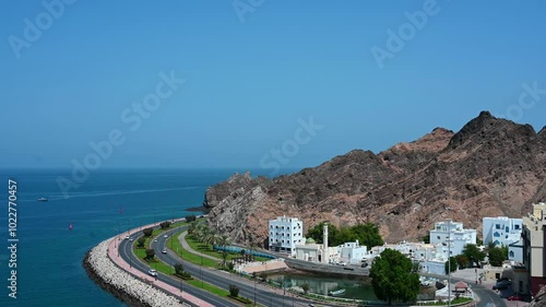 Panoramic view of old historical part Muscat Muttrah with embankment, mountains and sea in Oman