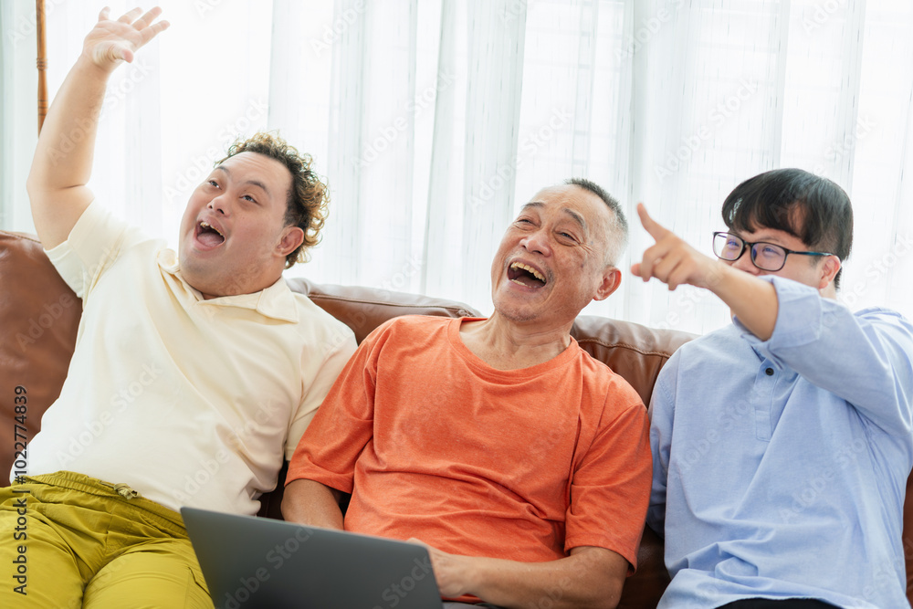 Obraz premium Cheerful grandfather and grandson in living room, Senior asian man having a good time sitting on couch at home with adult son